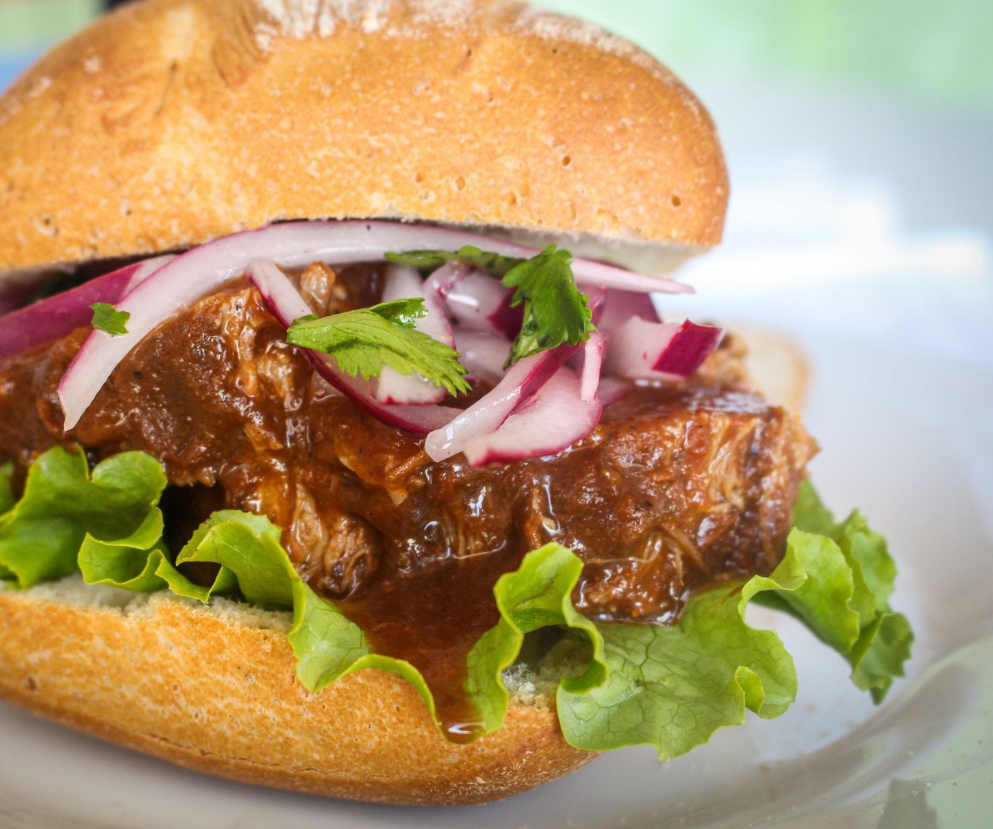 A large sandwich on a soft roll, piled high and served warm
